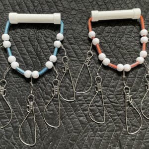 Two pairs of bracelets with pearls and a cell phone cord.