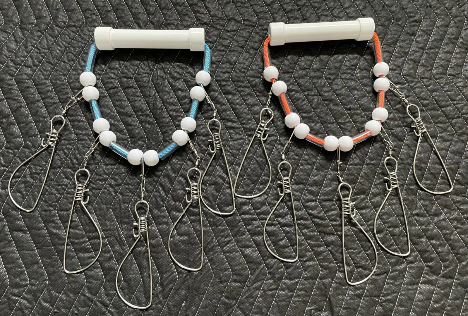 Two pairs of bracelets with pearls and a cell phone cord.