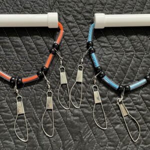 A pair of fishing rods with different colored cords.