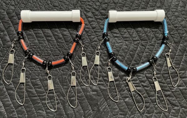 A pair of fishing rods with different colored cords.