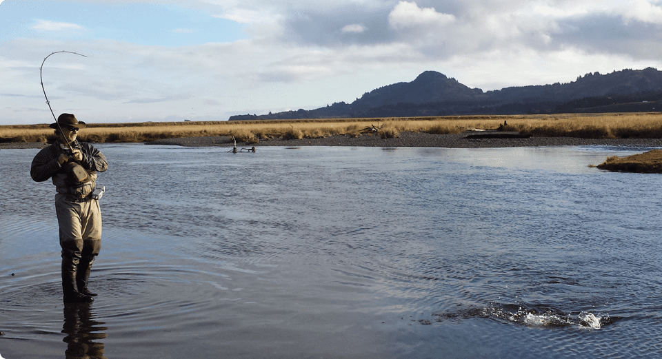 A body of water with two people in it.